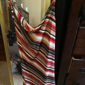Red, black, white, and tan dress with scooped neck, high/low